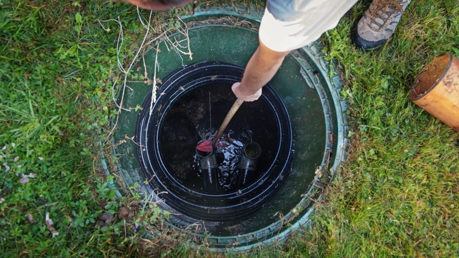 Technician performing septic tank cleaning