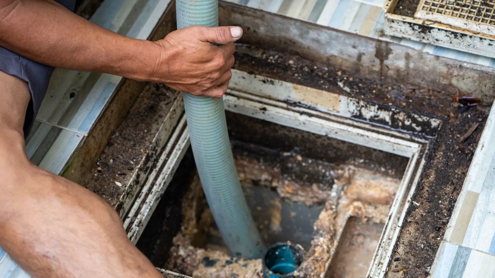 Technician inspecting septic chamber